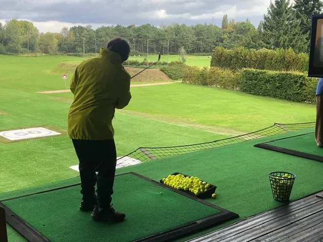 Teilnehmer beim Abschlag auf der Driving Range im Golf Lounge Resort