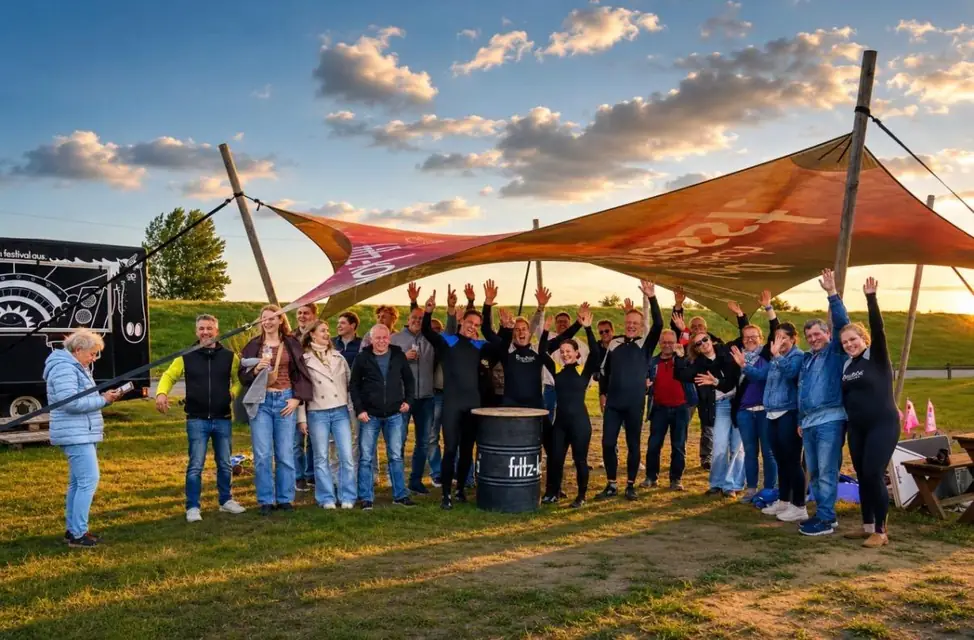 Group photo of the Golf Lounge team under the sun sail in the evening
