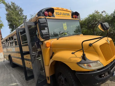 Golf Lounge's yellow American school bus with open door at the MediA-marketing company summer party